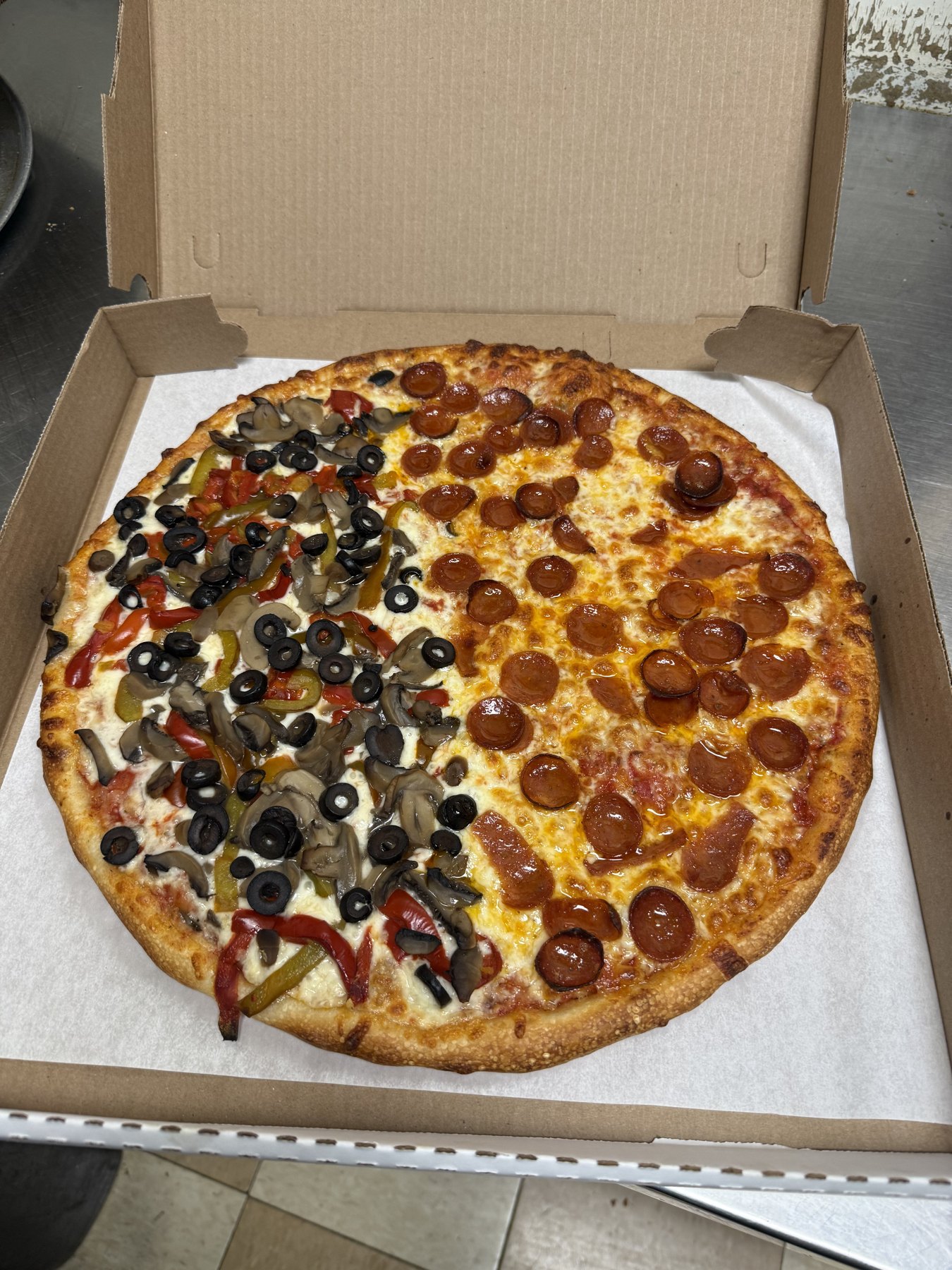 A fresh Fred's pizza with pepperoni and vegetables